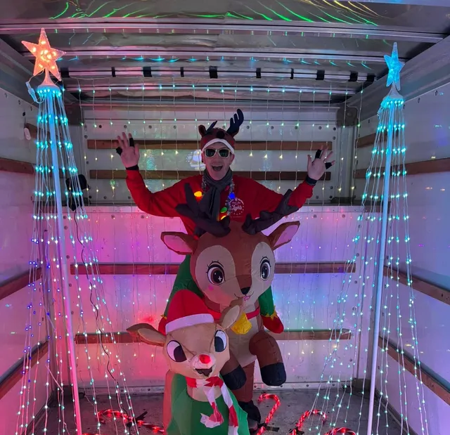 Brian and Multiple Rudolph inflatables in a U-Haul decorated for the holidays.